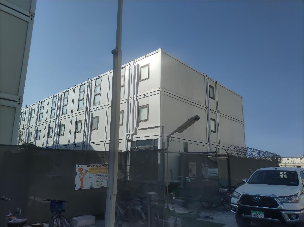 Row of multi-storey modular accommodation buildings viewed from the access road