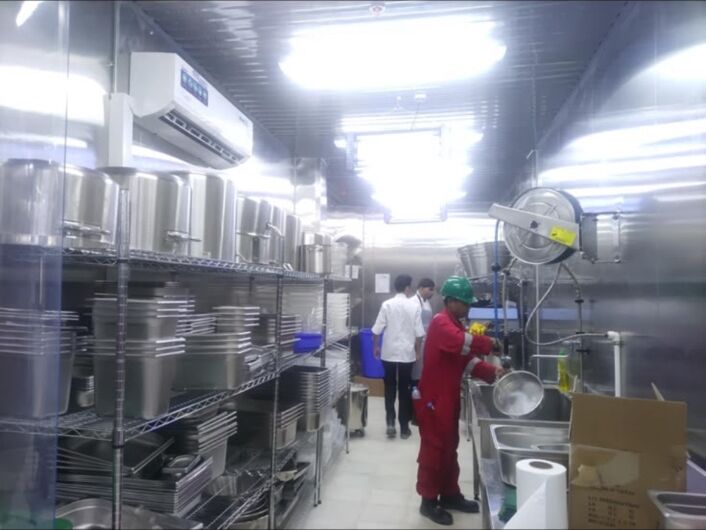 Kitchen area with large cooking pots and stainless-steel wash benches