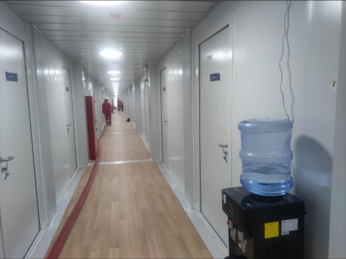 Accommodation corridor with a drinking water point beside the room doors