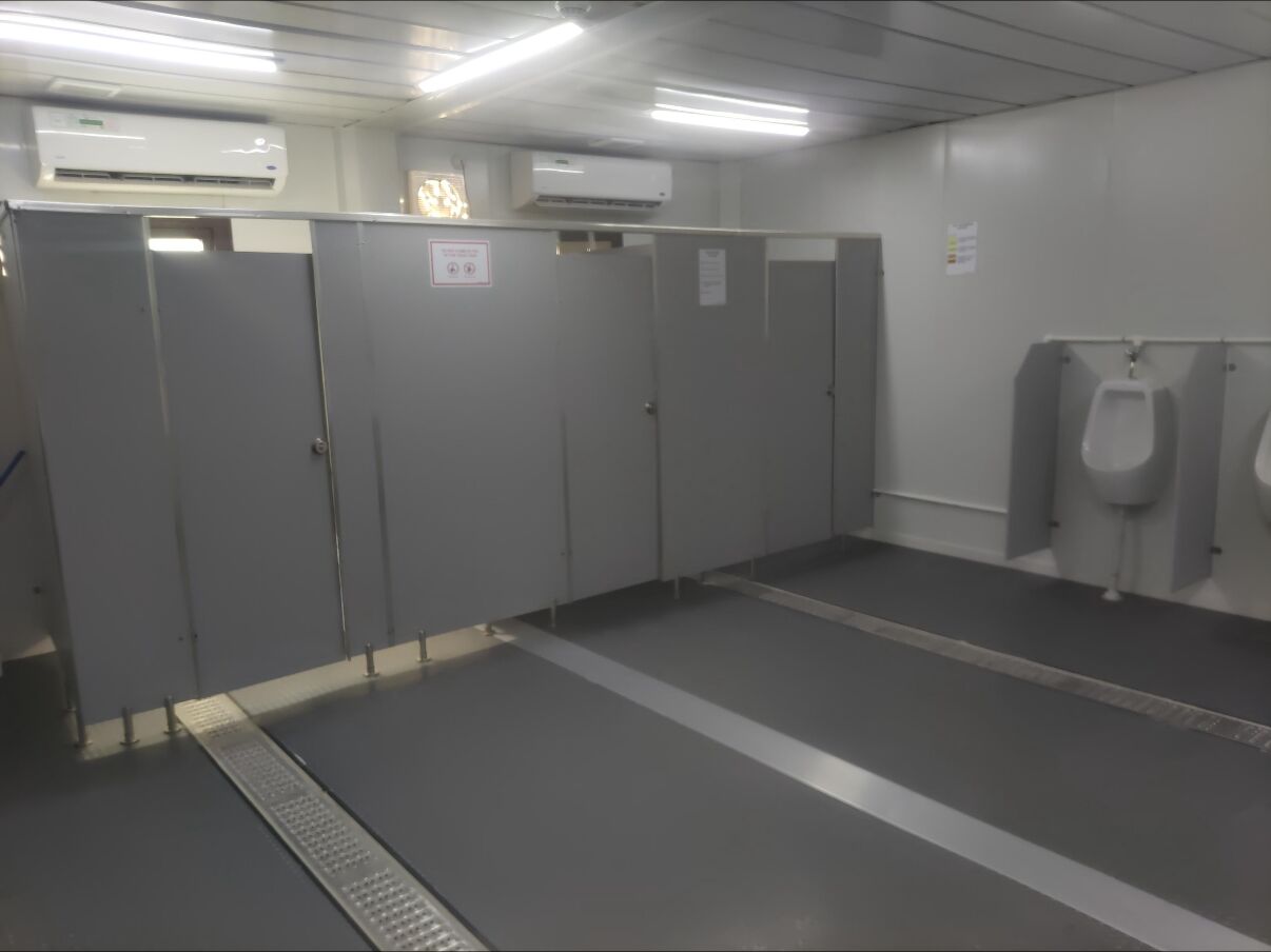 Office-building washroom with toilet cubicles and urinals