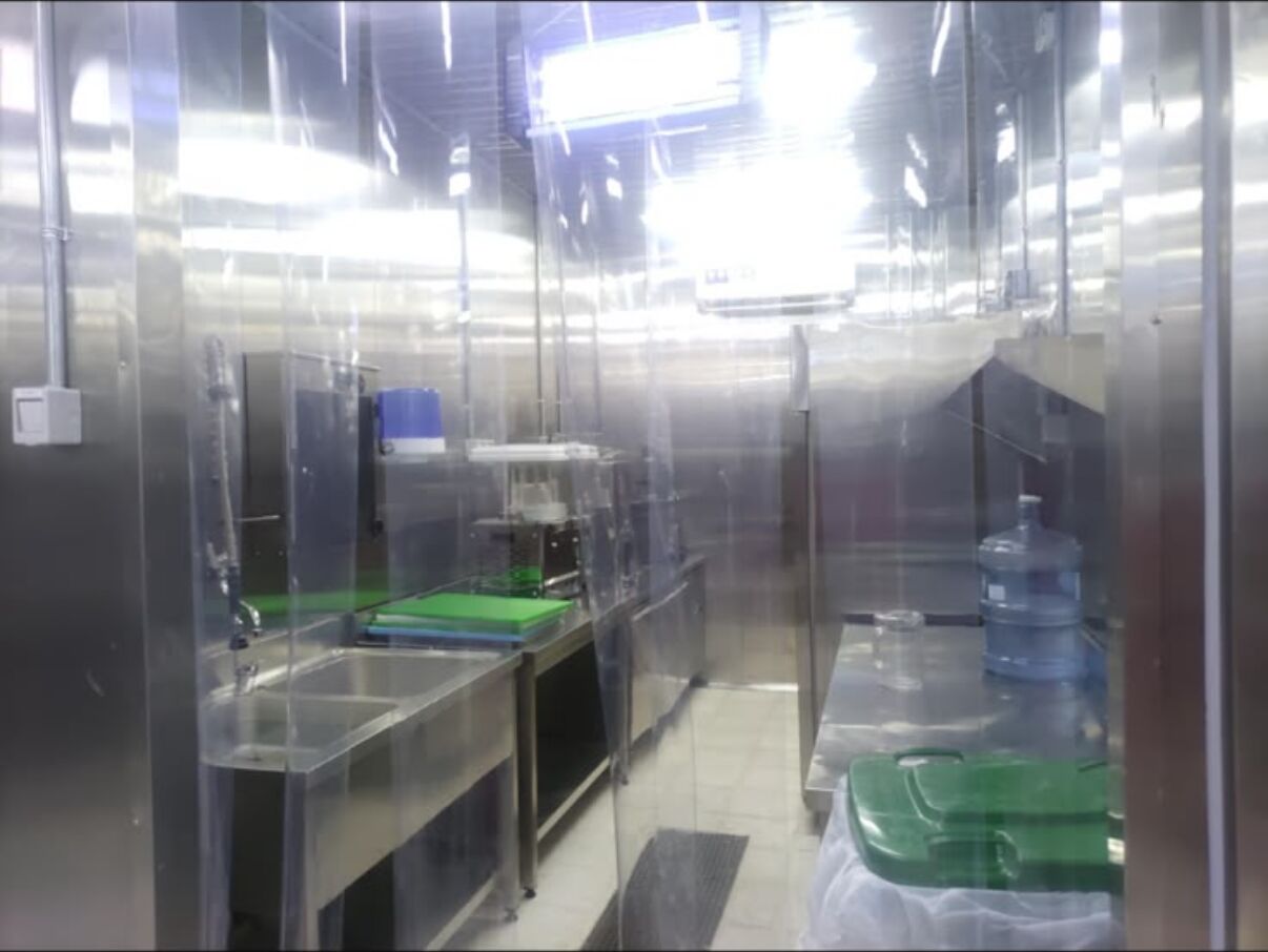 Pot wash area with stainless-steel sinks and drainage channels