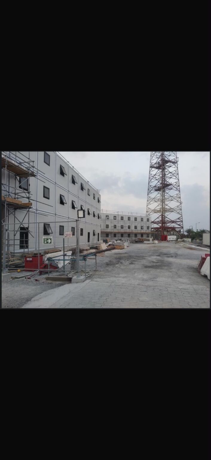 Modular accommodation building under construction with external access scaffolding