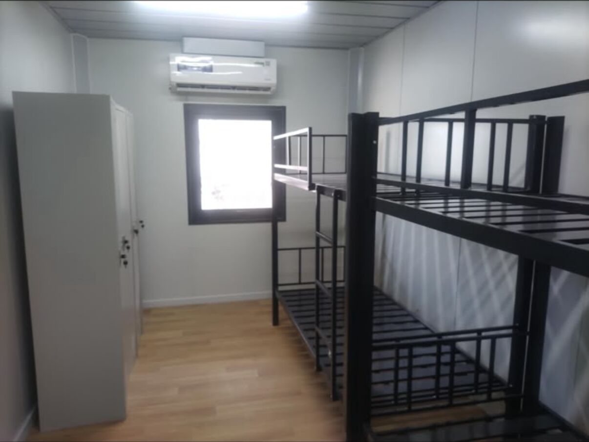 Labour accommodation room with bunk beds and a wardrobe unit