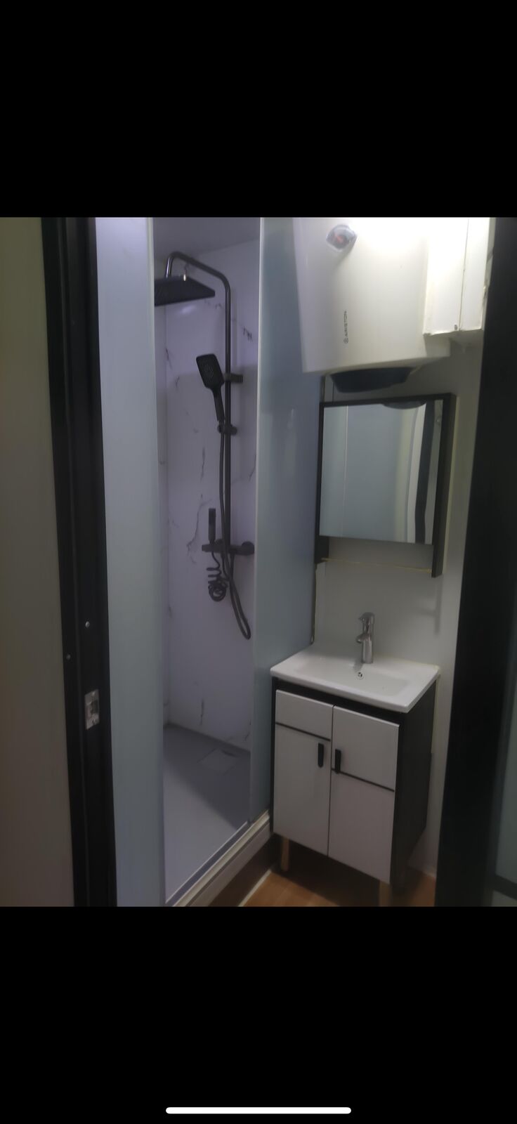 Senior shower room with shower, vanity unit and mirror