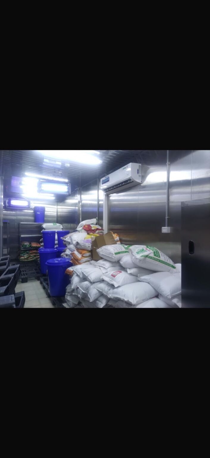 Vegetable preparation area with stainless-steel benches and produce storage