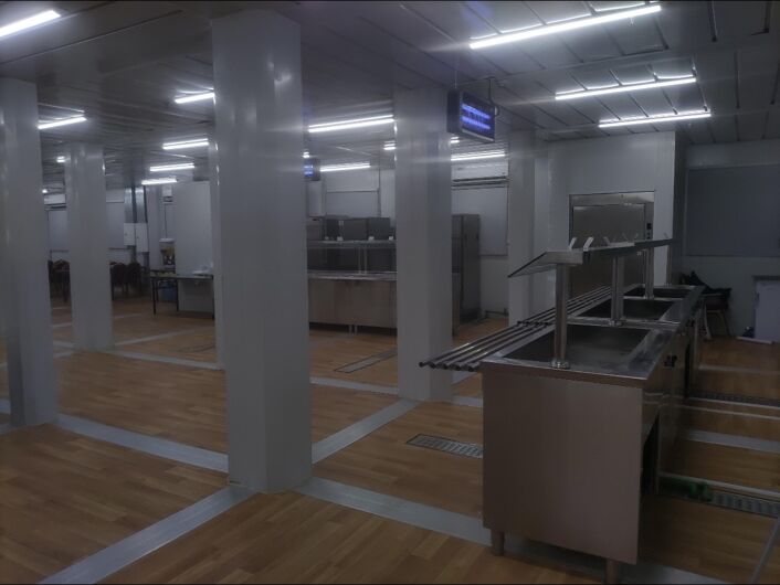 Mess hall serving area with service counters and circulation space